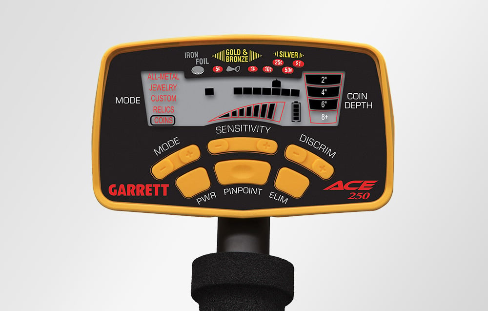 Close-up on the control panel of the Garrett ACE 250 metal detector with buttons and display.