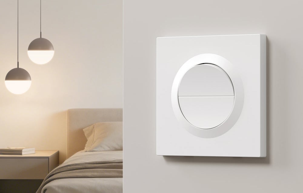 Elegant SONOFF Orb-MW2 switch on the wall, with bed and pendant lights in the background