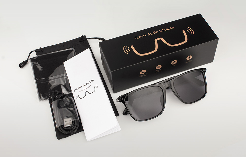 A set containing the glasses, a case, a user manual, and a charging cable in black packaging.