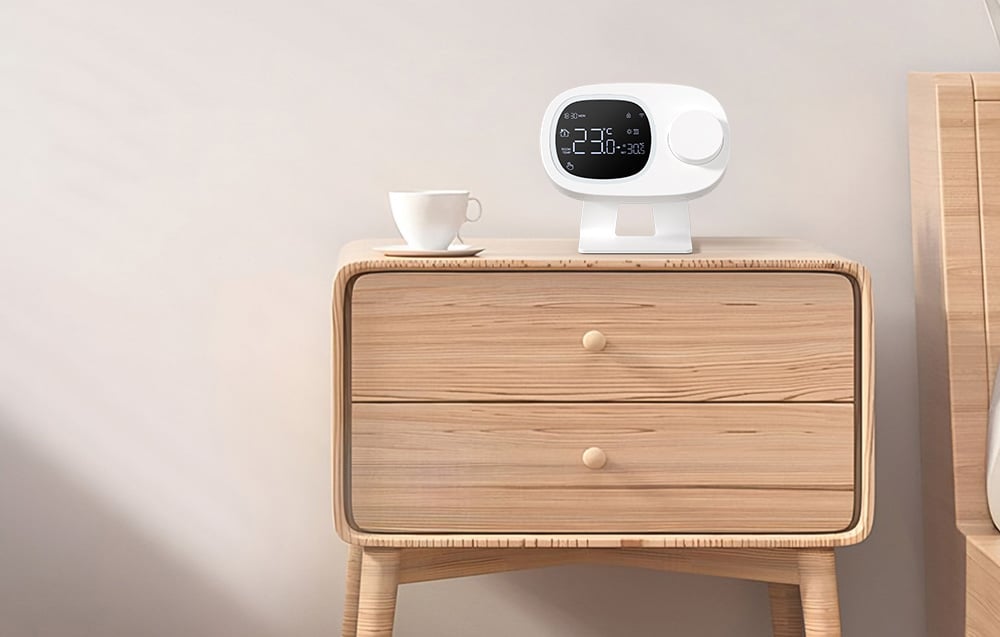 Smart thermostat on the wooden nightstand next to the cupboard