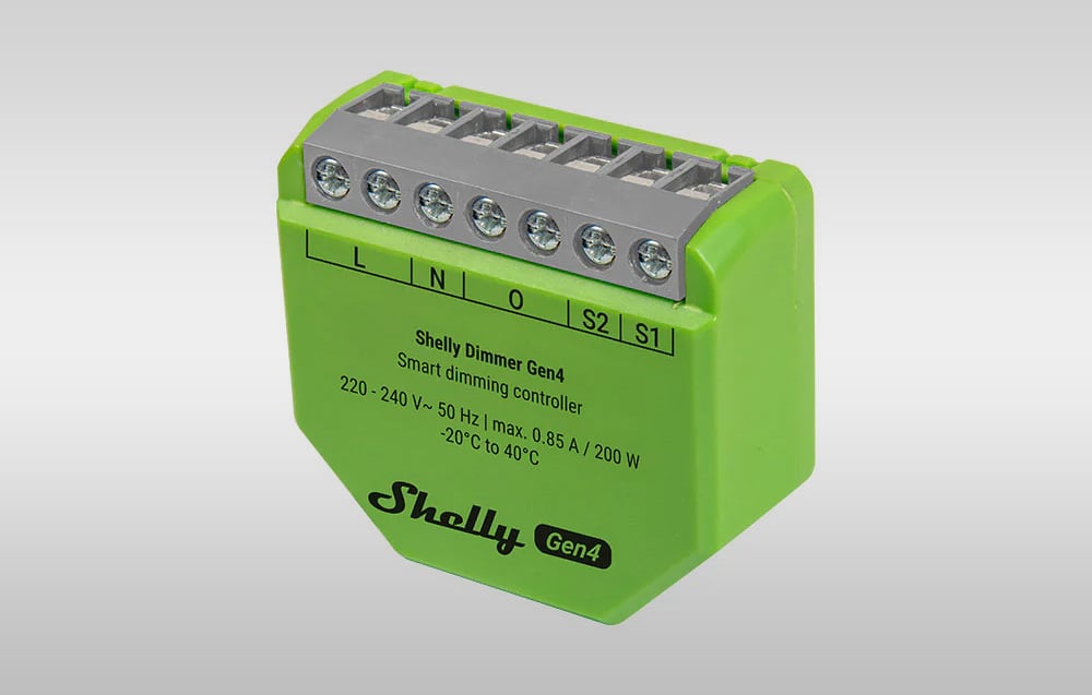 Control device in a green housing positioned vertically, with visible labels indicating operating parameters and a terminal block.