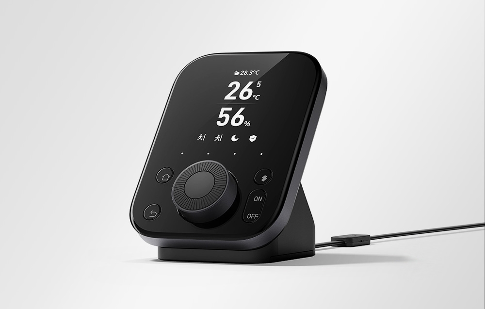 Minimalist SwitchBot remote control in black with power cable, side view