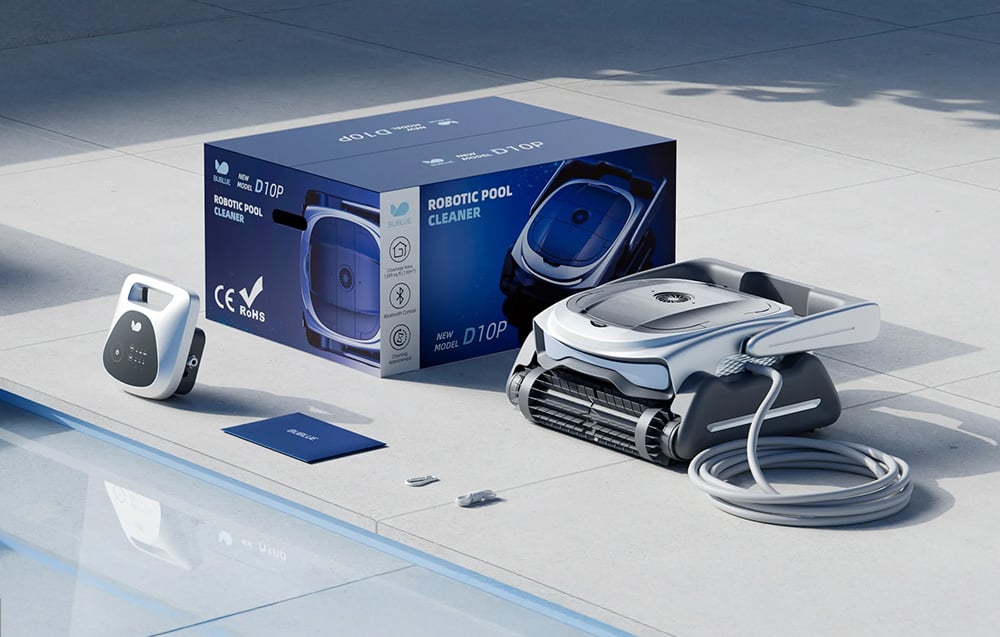 The pool robot lies on the patio next to the packaging, power module, manual, and small accessories