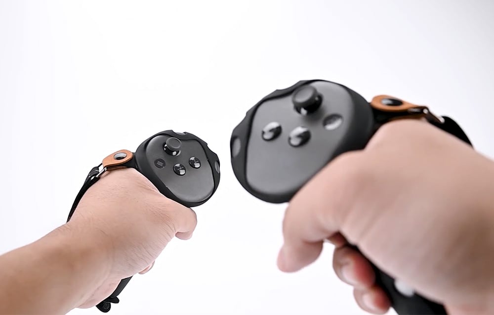 Hands holding controllers with covers