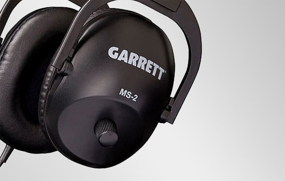 Close-up of the black headphone housing featuring the Garrett logo, the MS-2 model, and the volume control knob.