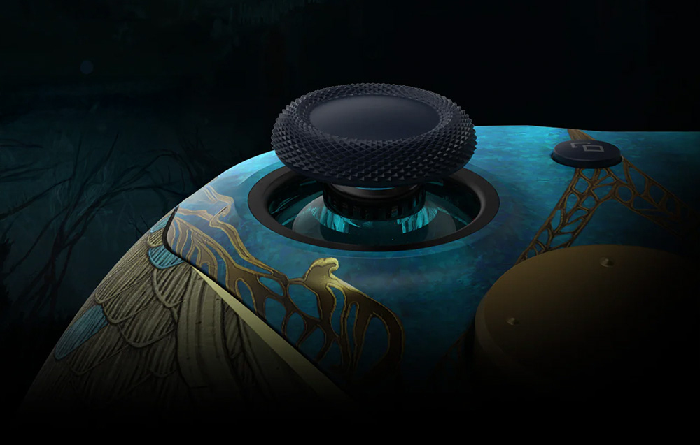 A close-up of the textured analog stick of the decorative controller with a blue and gold pattern