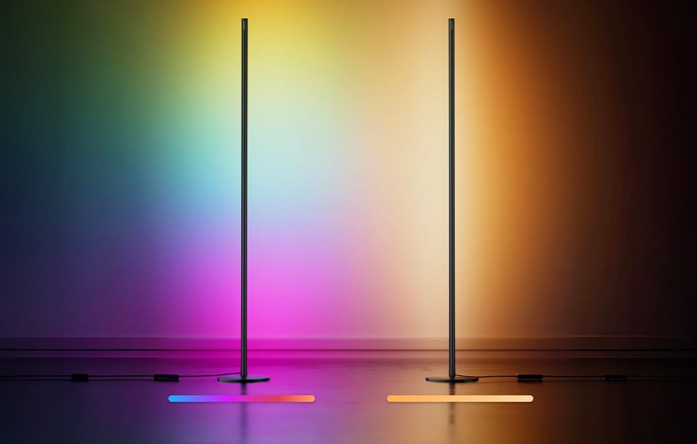 Two minimalist floor lamps, one of which emits multicolored light, and the other warm, yellow light.