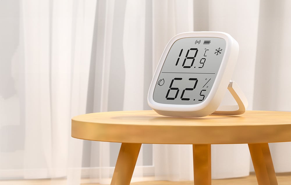 Temperature and humidity sensor on a wooden table in a bright room