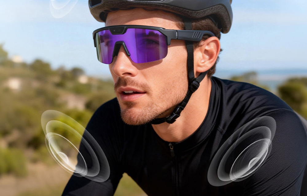 A man riding a bike wearing a helmet and purple AI glasses