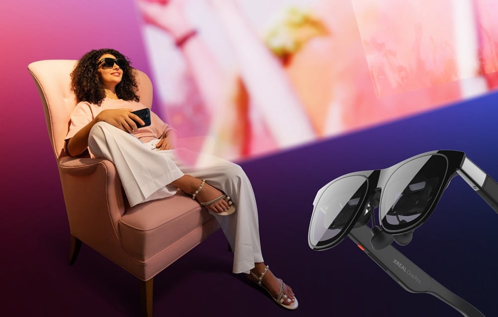 smiling woman sitting on an armchair and using AR glasses