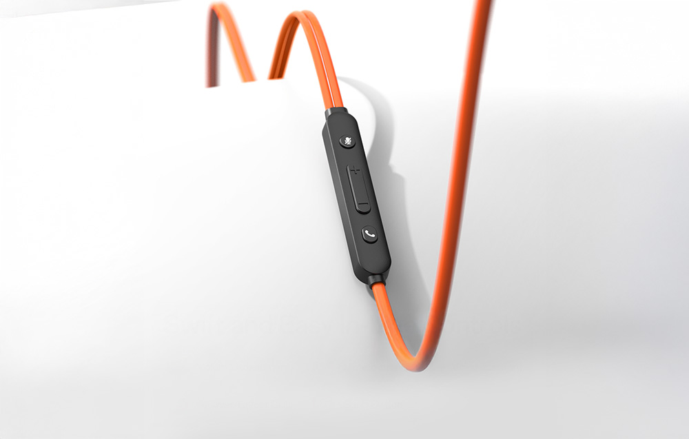Black remote control with buttons integrated with orange cable on gray background