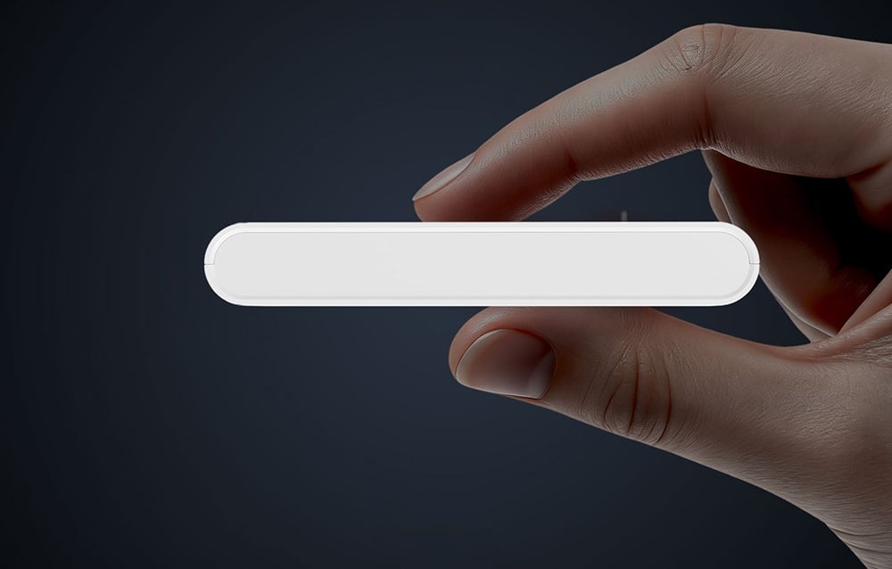 A white sensor held in the hand