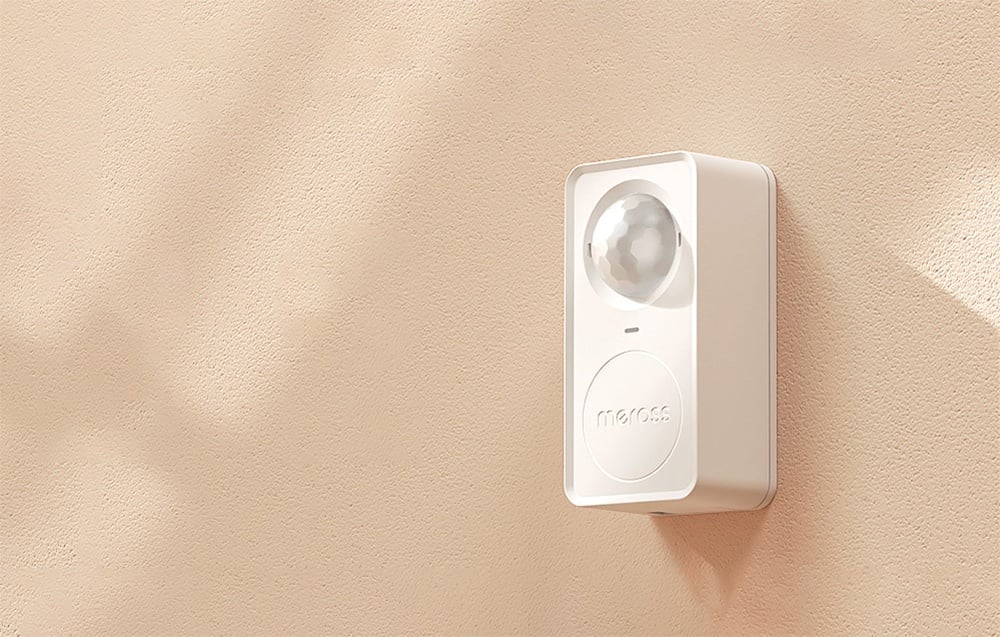 White Meross motion sensor mounted on beige wall