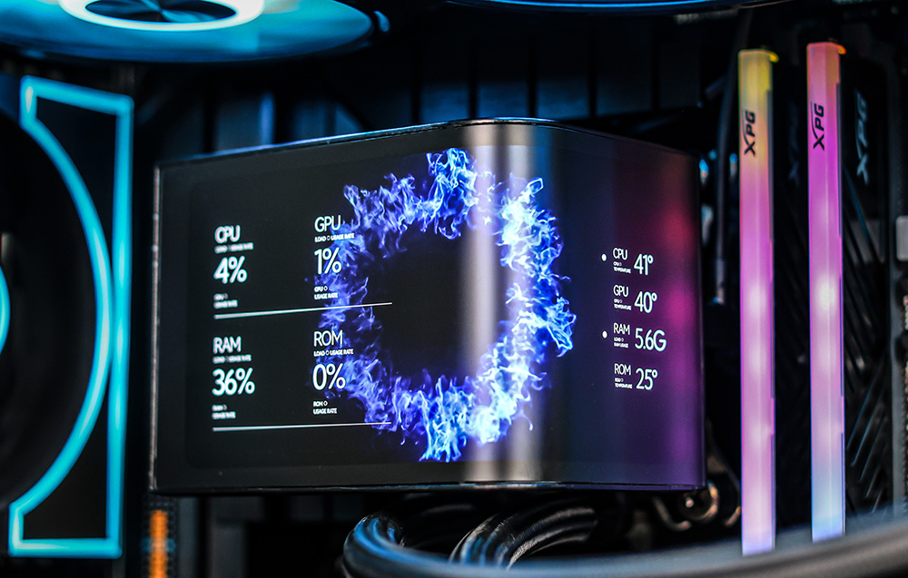 Close-up of the curved screen on the CPU water cooling block-pump displaying temperatures and component load