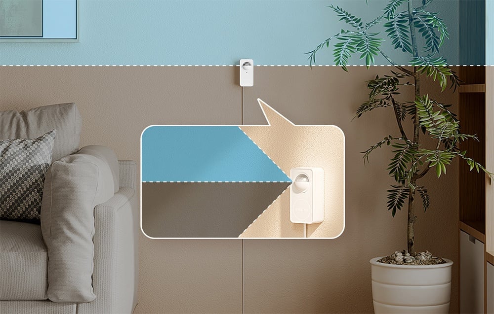 Motion sensor mounted on the border of two wall colors, with a zoom showing its presence against the interior background