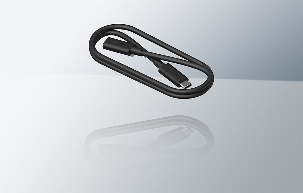 Coiled black USB-C cable by VITURE with its reflection on a shiny bright surface