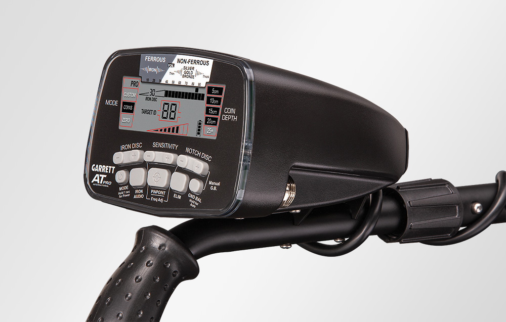 Metal detector control panel with buttons and LCD screen.