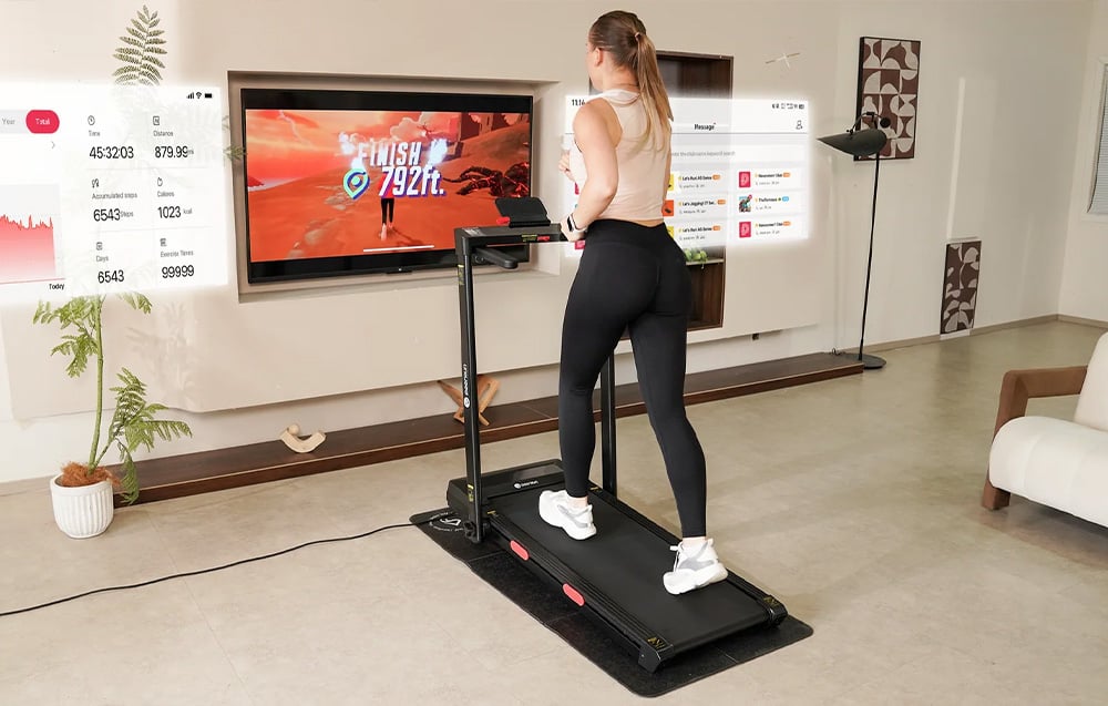 A woman running on a treadmill with a white stand during an interactive workout displayed on a TV