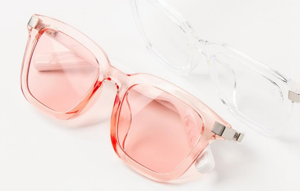 Pink and transparent glasses on a white background