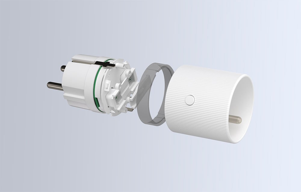 A smart plug taken apart with internal components visible.