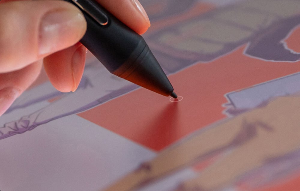 Close-up of the stylus touching the tablet's screen while digitally painting
