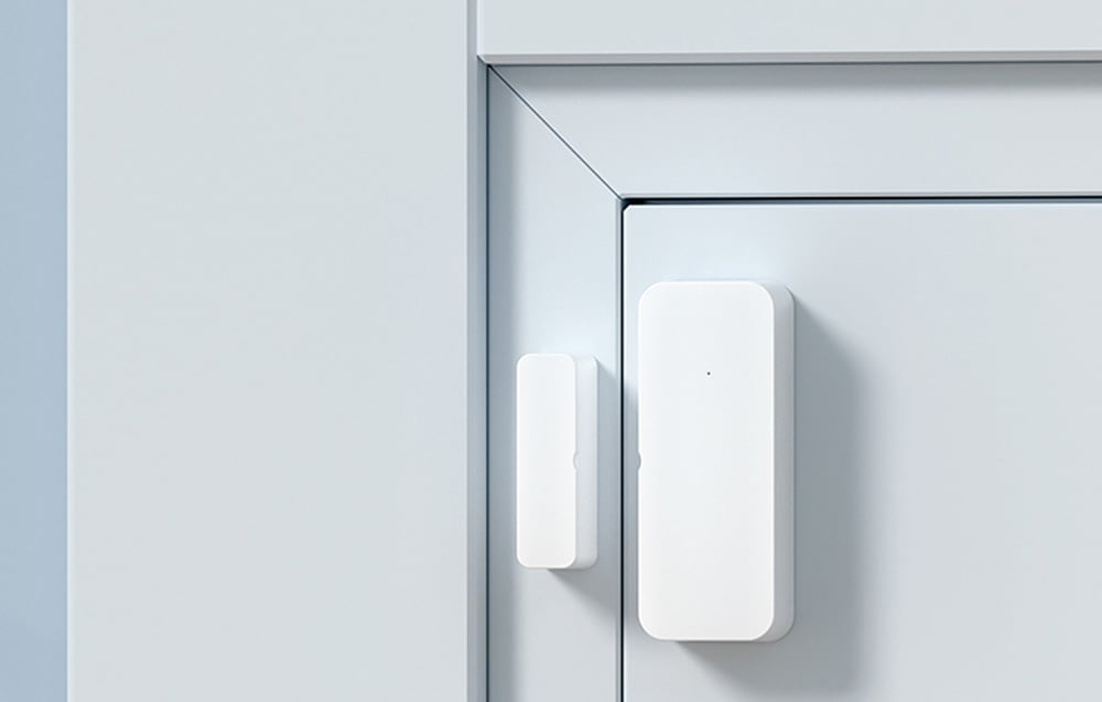 Close-up of the door and window opening sensor mounted on the white door frame