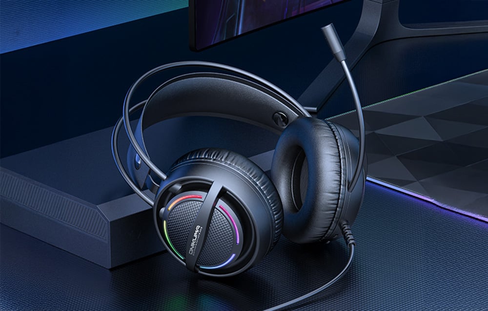 Black Onikuma headphones with microphone on black desk