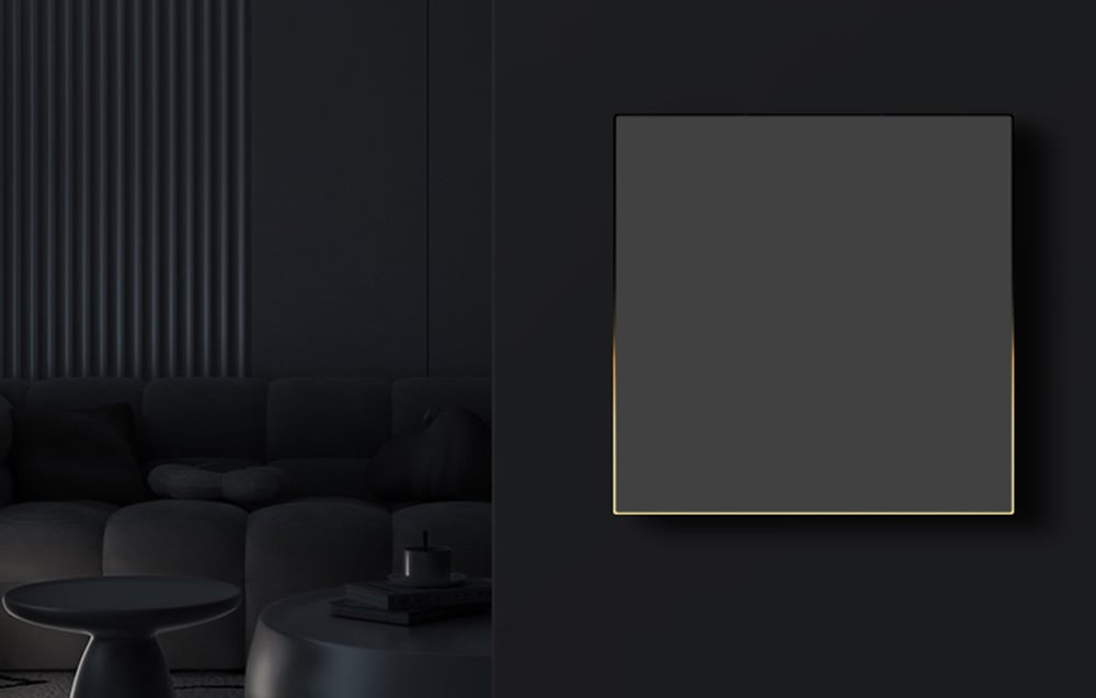 Black touch panel with yellow backlighting on a black wall in a minimalist dark interior