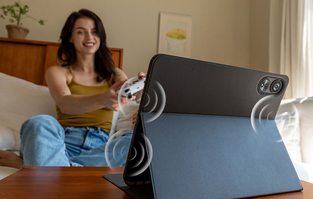 A woman playing with a tablet pad in a case with sound stamps showing stereo speakers