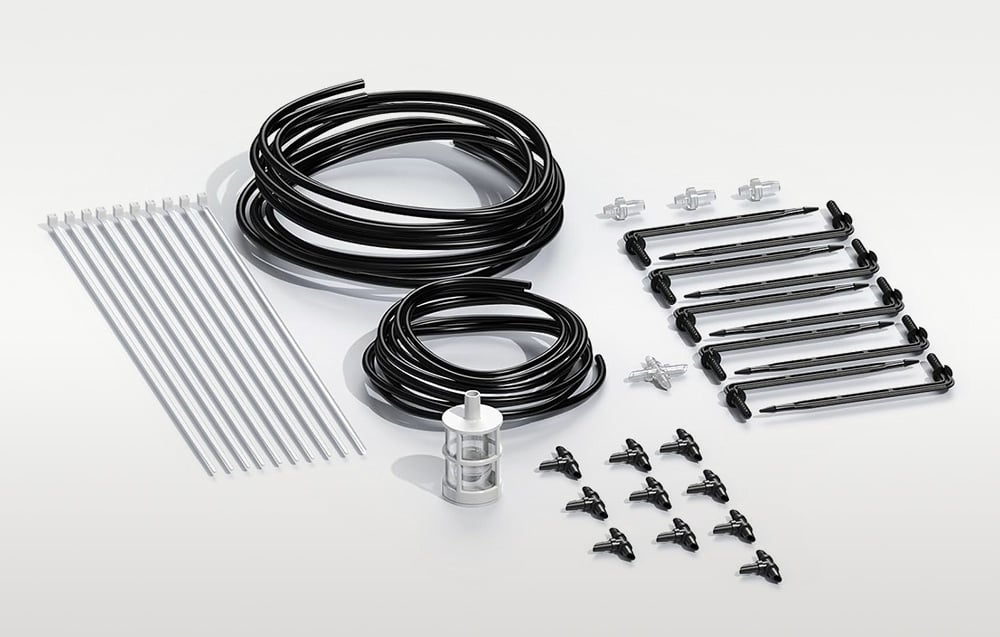 Components for the installation kit, including cables, emitters, spikes, zip ties, tees, connectors and filter laid out side by side