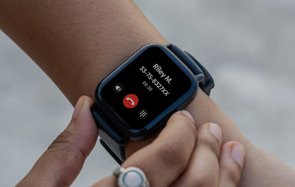 Close-up of the black smartwatch on the wrist while answering a phone call from Riley M