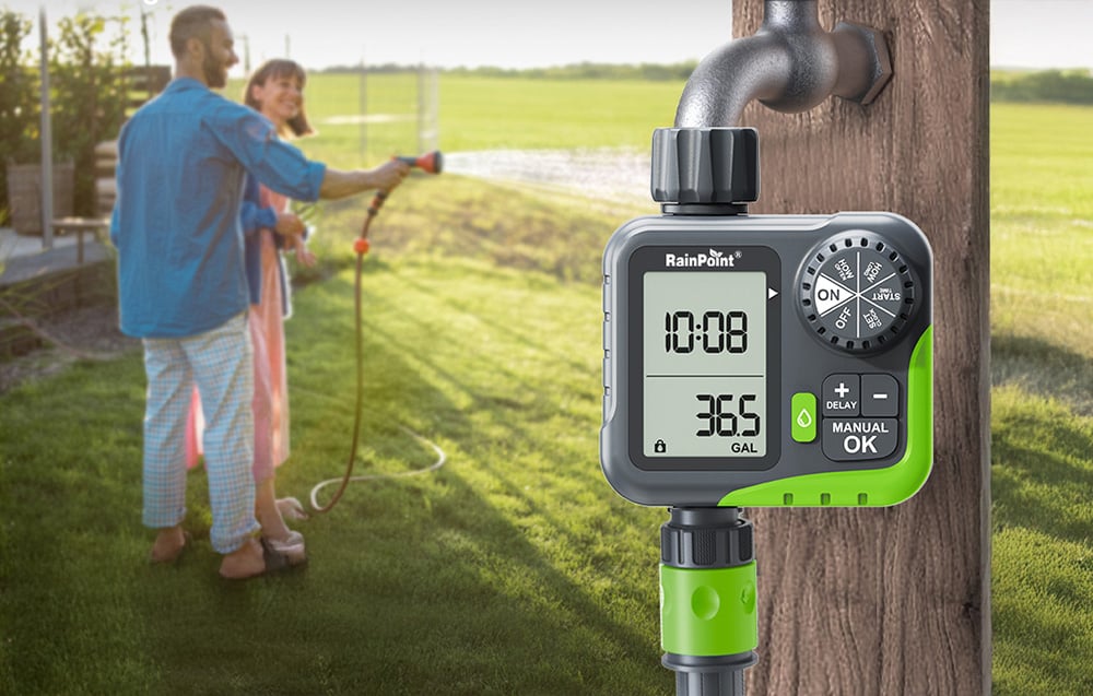 RainPoint controller on a faucet in the garden; in the background, a couple watering plants with a traditional garden hose