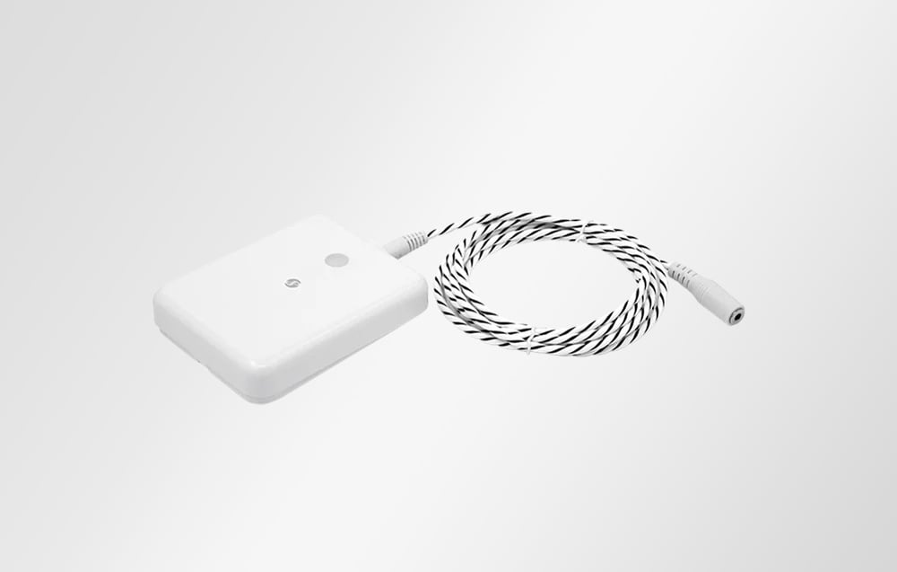 White flood sensor with connected black and white cable on white background