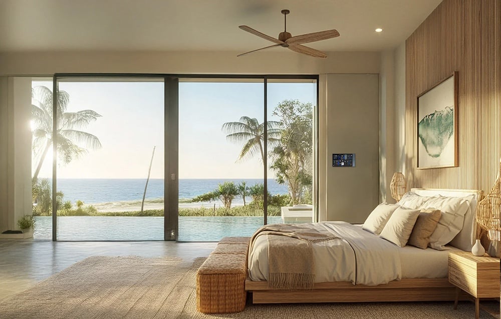 Luxurious bedroom with control panel on the wall and ocean view through glass doors
