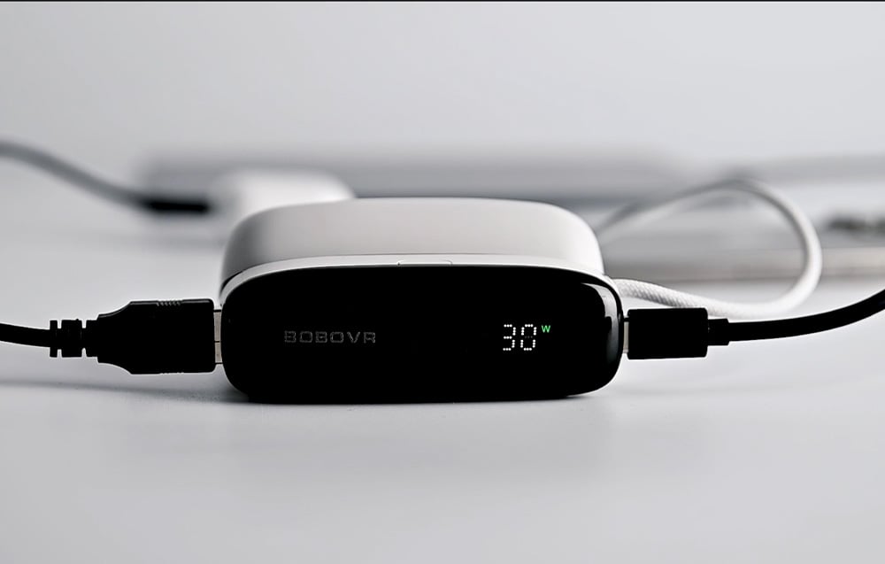 Close-up of the front panel of the BoboVR PD100 with the display showing 30W charging power and connected cables