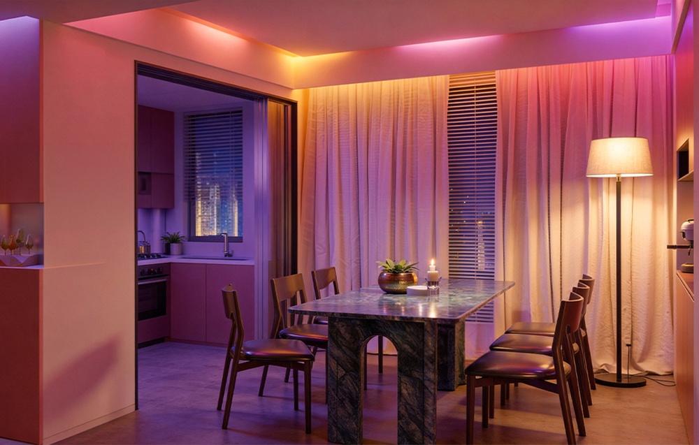 A dining room with a dark table and chairs, illuminated in colorful lights using LED strips