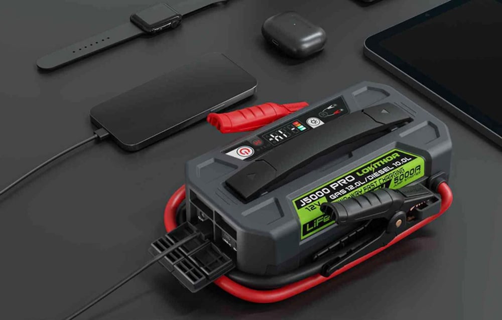 The device serving as a power bank, charging a smartphone and a watch via cables connected to the side ports.