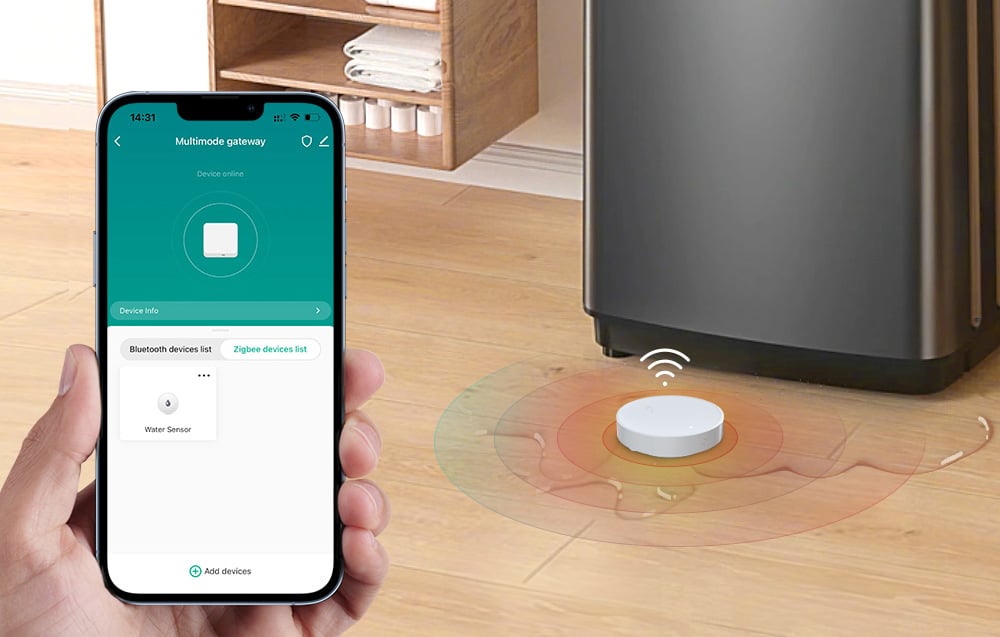 Flood sensor on the floor next to a washing machine, next to a smartphone with an app detecting the device