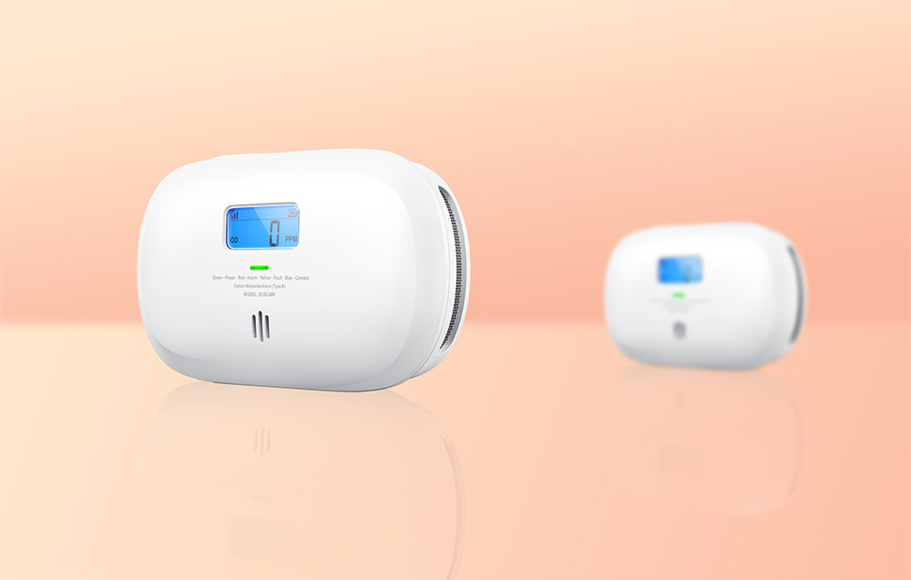 Two X-Sense carbon monoxide detectors, a larger one with LCD display and a smaller one, on a bright orange background