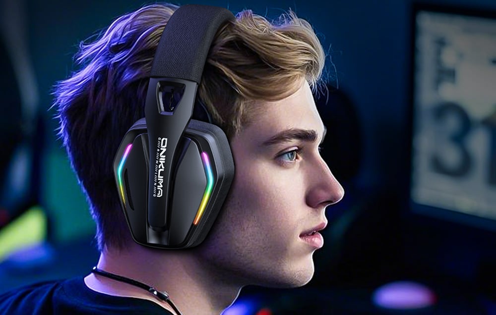 A man standing in profile facing the camera wears Onikuma headphones