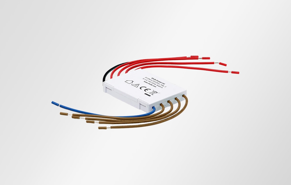 Shelly 4-Channel Decoupler module seen from the side, with numerous brown and red wires spread on a white background