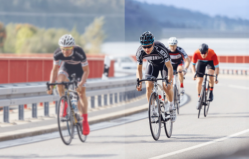 A group of road cyclists in sports attire riding in formation on the road