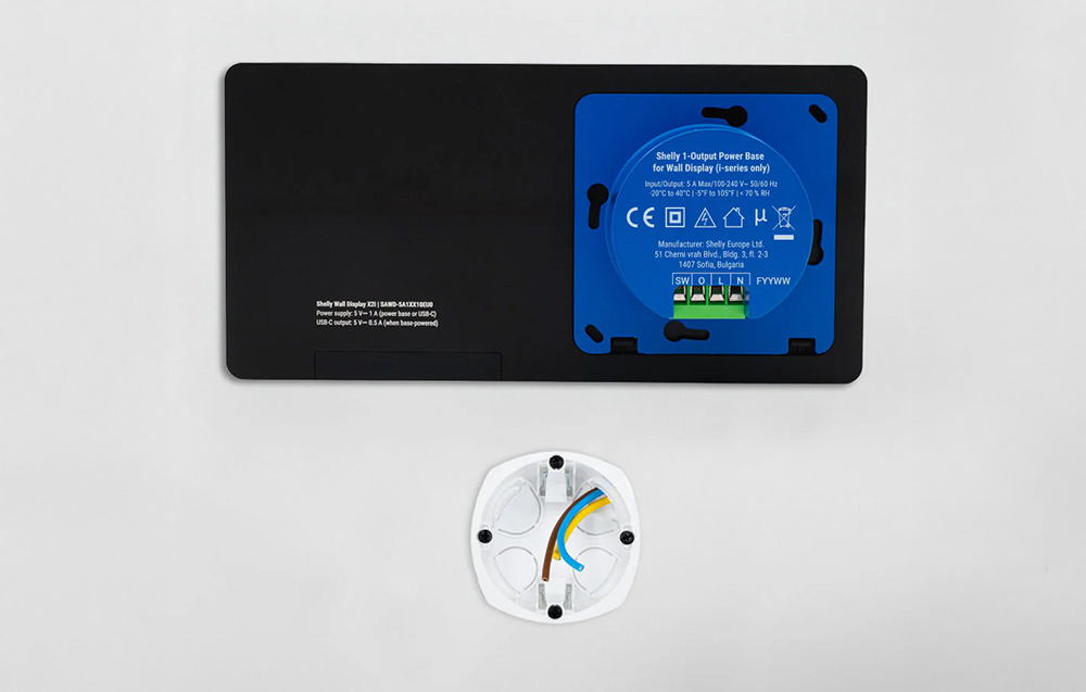 The back of the Shelly Wall Display X2i panel with the power base and wiring diagram in the electrical box visible.