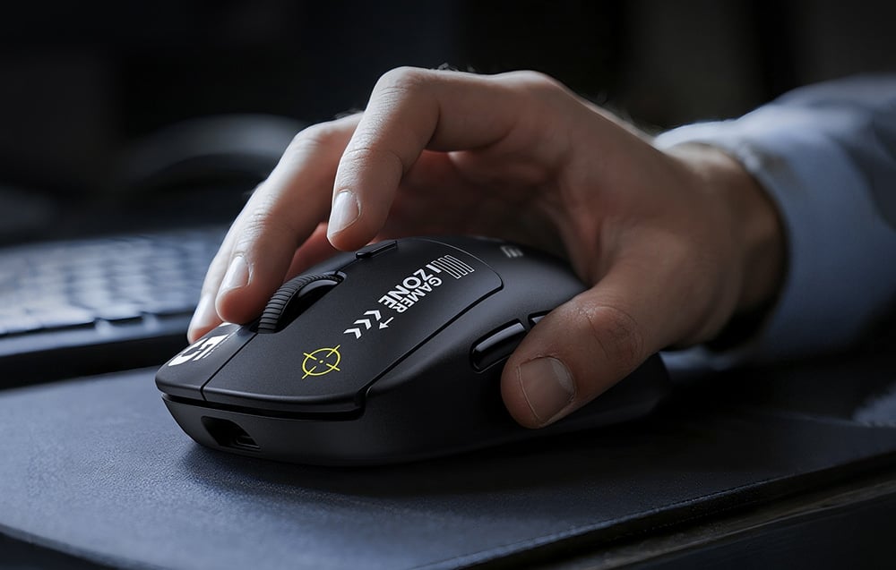 Close-up of a hand resting on a black computer mouse