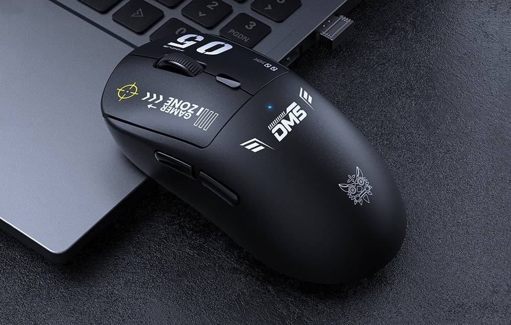 Black computer mouse resting on a gray laptop