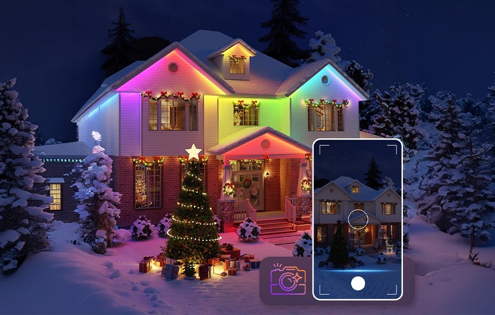 A Christmas tree and a house with colorful LED lighting in a snowy setting, controlled by a smartphone.