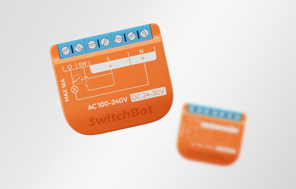 SwitchBot module with visible wiring diagram, MAX 16A, second module smeared in the background