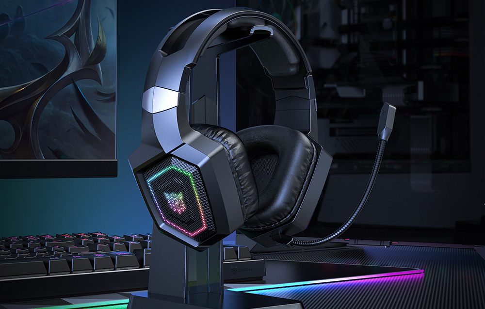 Onikuma gaming headphones hanging on a bracket, monitor and keyboard can be seen in the background