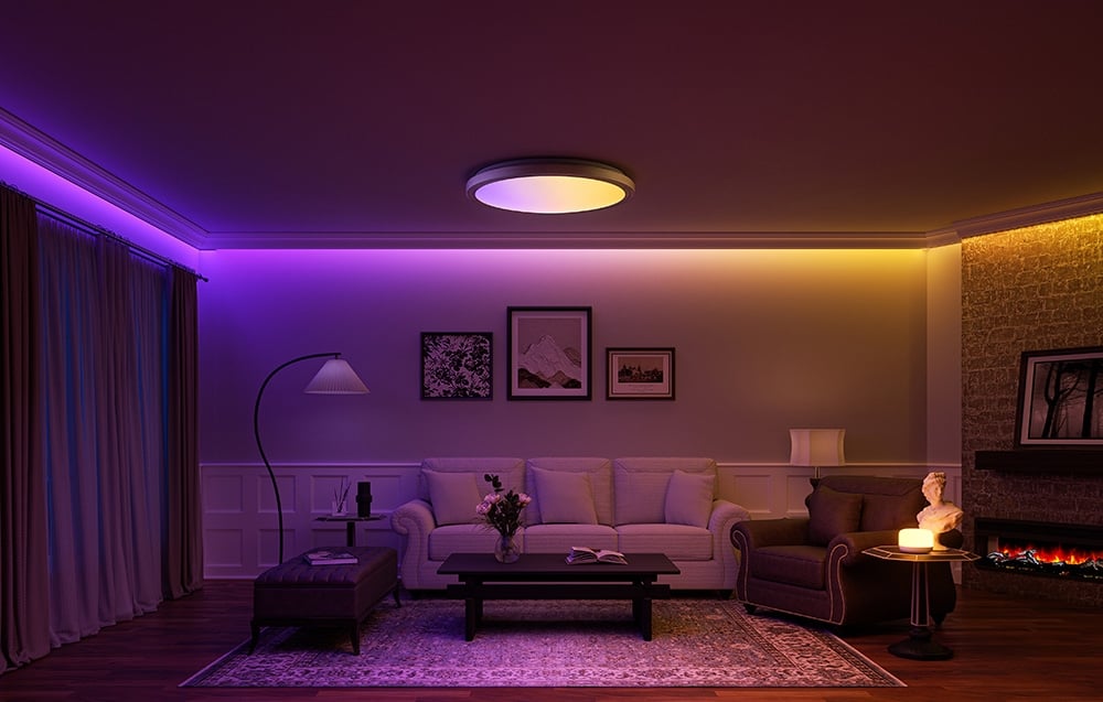 Living room with fireplace and Yeelight Jupiter D C400 lamp, lit in purple and yellow.