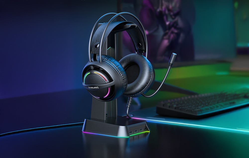 Onikuma in-ear headphones on illuminated stand on dark desk